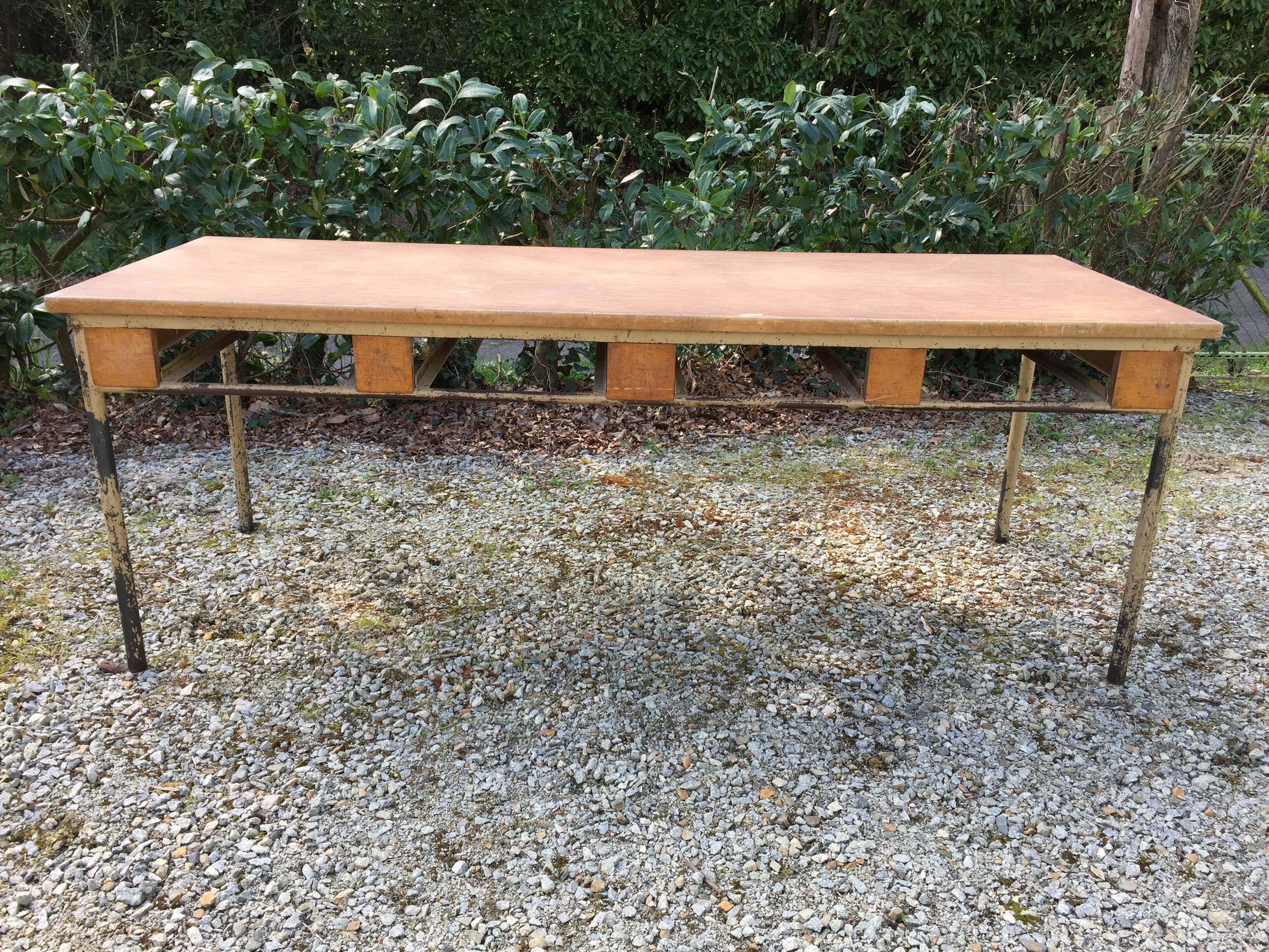 Vintage modernist table with metal tubular base and top covered with oilcloth.