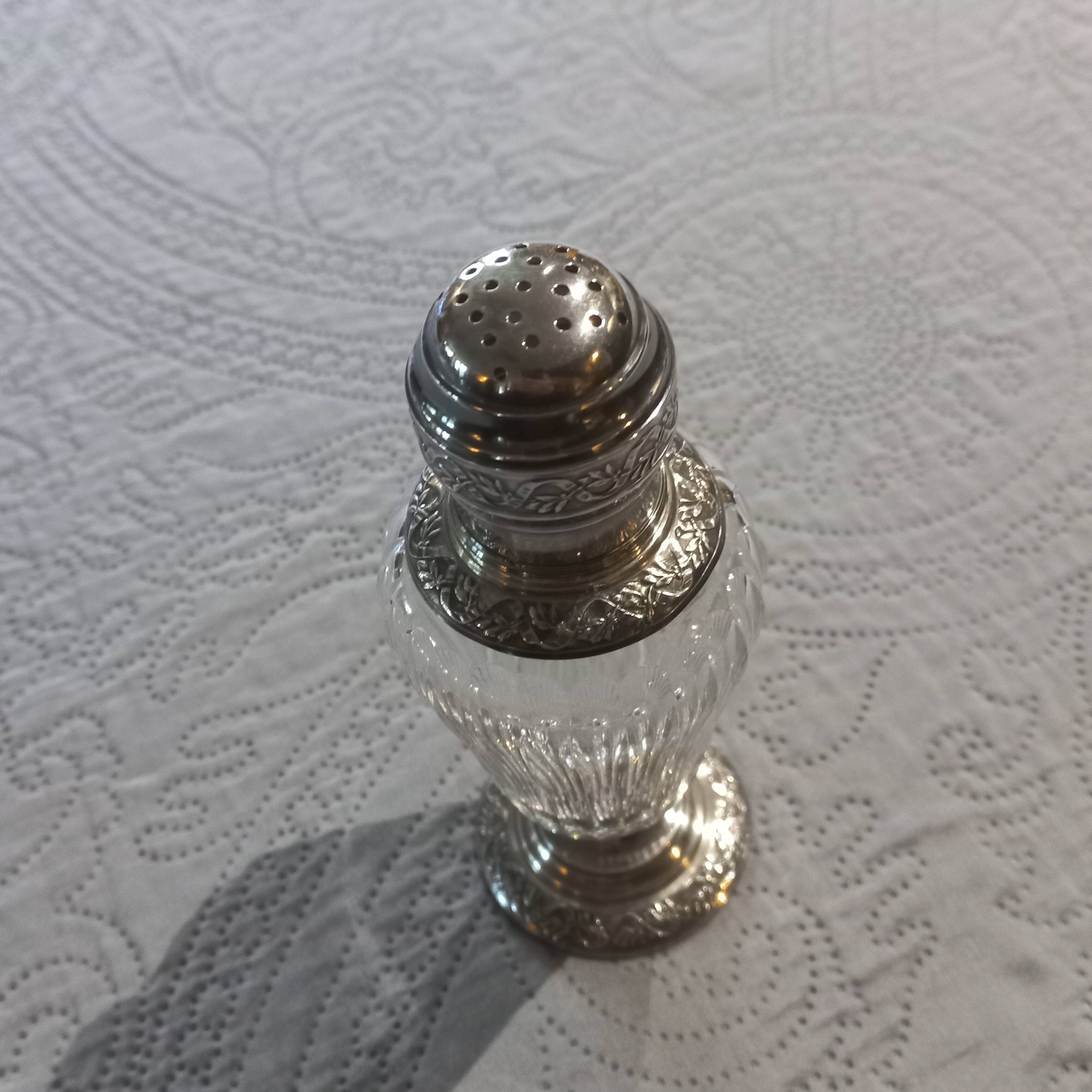 Crystal and solid silver shaker, neck brace and master's mark.