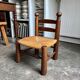 Low brutalist chair in dark wood and straw n°1