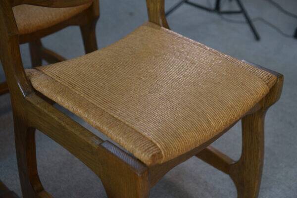 Set of 6 oak dining chairs with rush seat and 'Echelle' backrest in the style of Guillerme et Chambron 1950s
