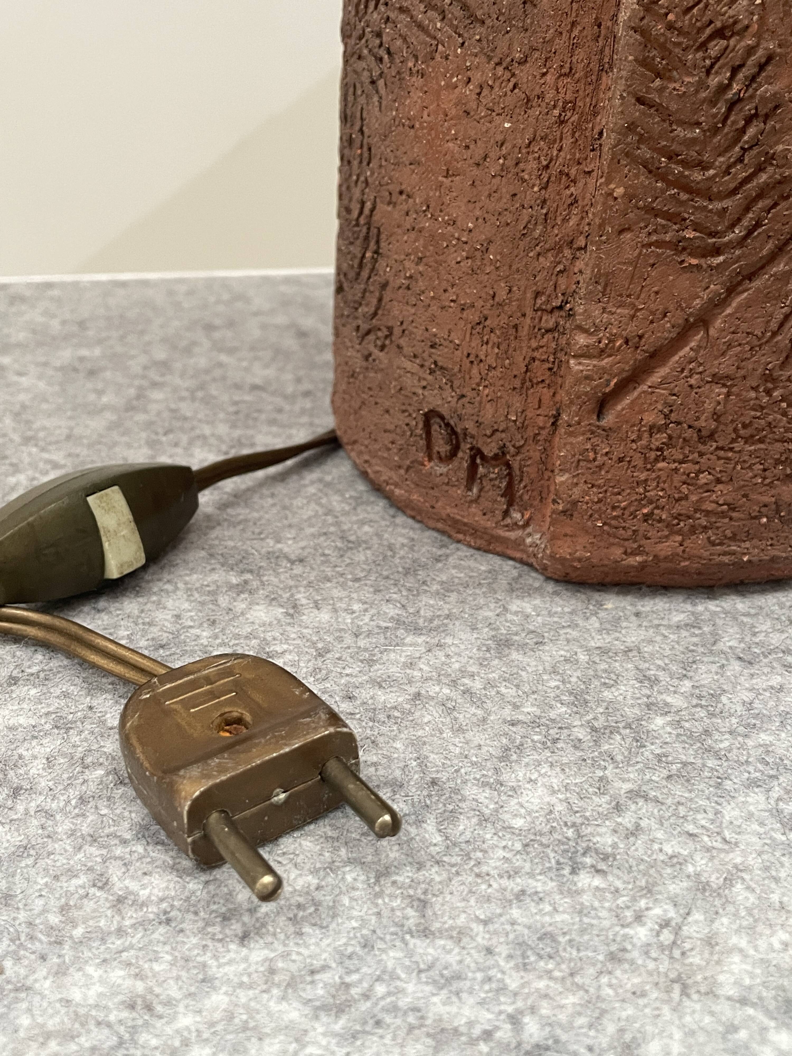 Large chamotte clay lamp in brutalist style, with a plant motif.