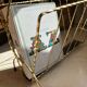 Vintage gold metal magazine rack from the 1960s.