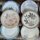 13 mismatched flat plates in ironstone