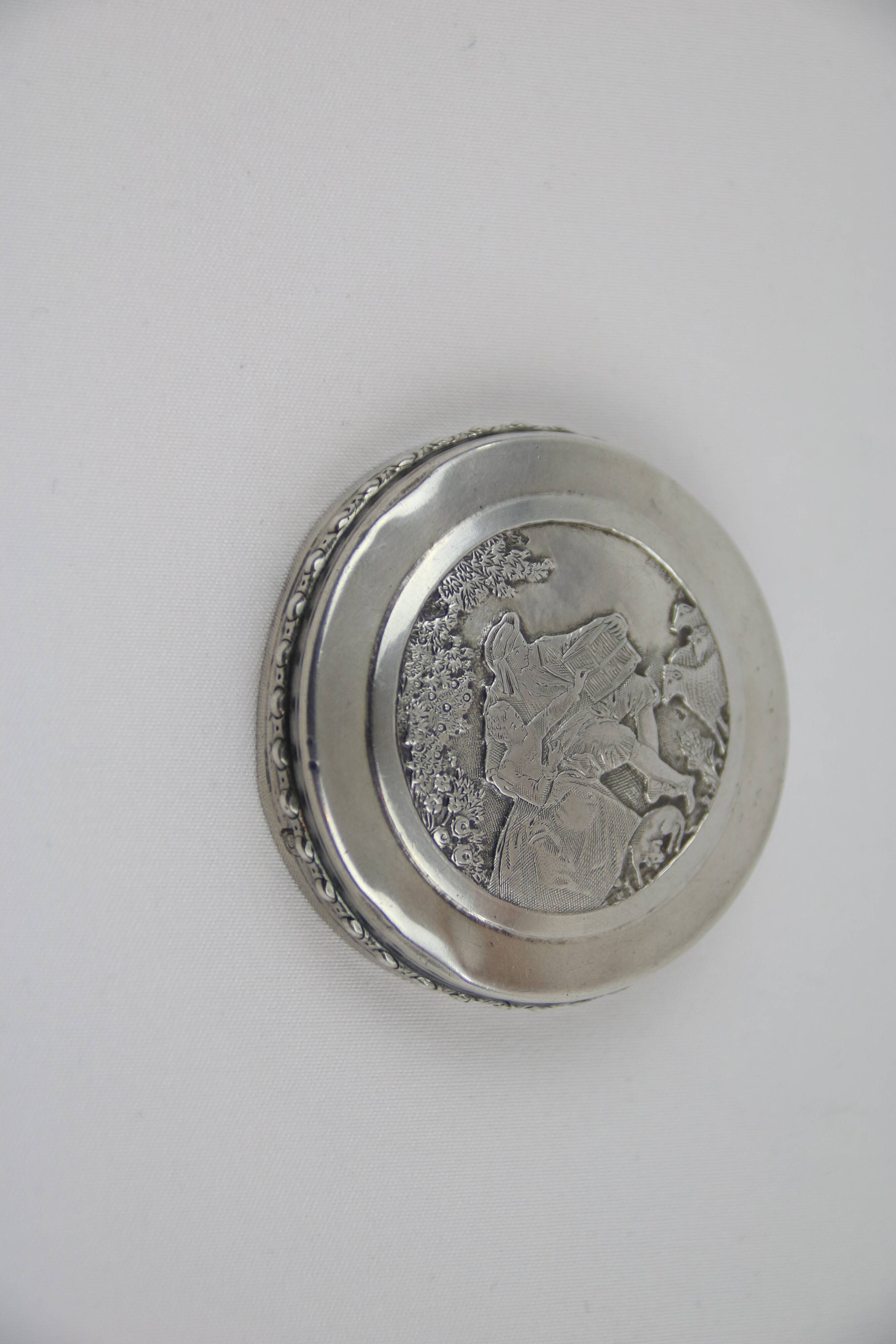 Small round box with silver pills