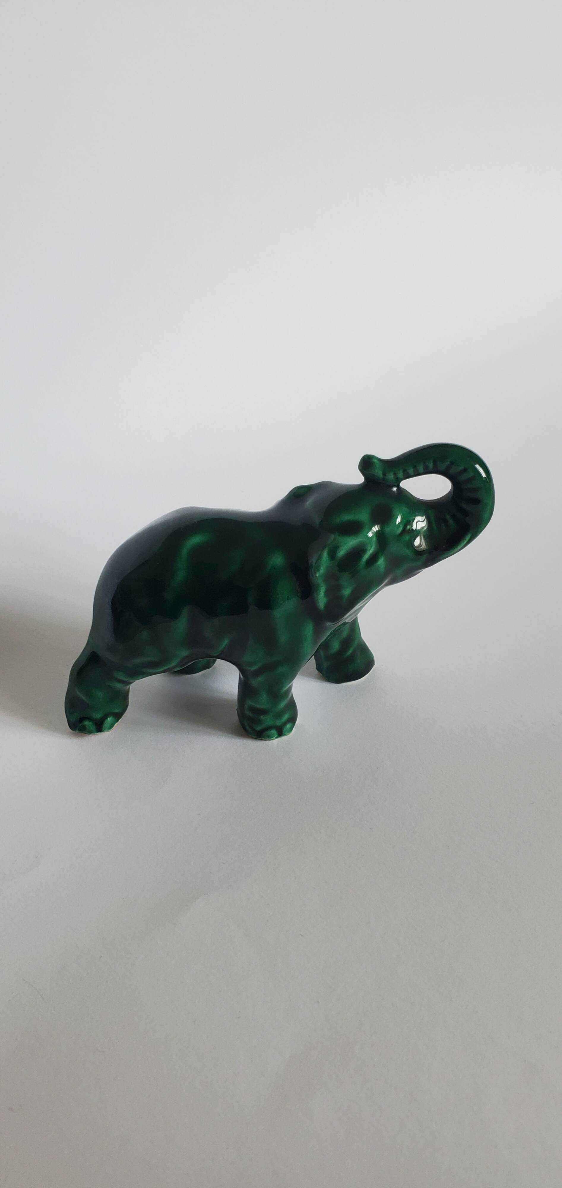Small emerald green ceramic elephant.