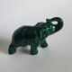 Small emerald green ceramic elephant.