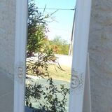 Large wooden mirror on tilting psyche stand in whitewashed gold with molding