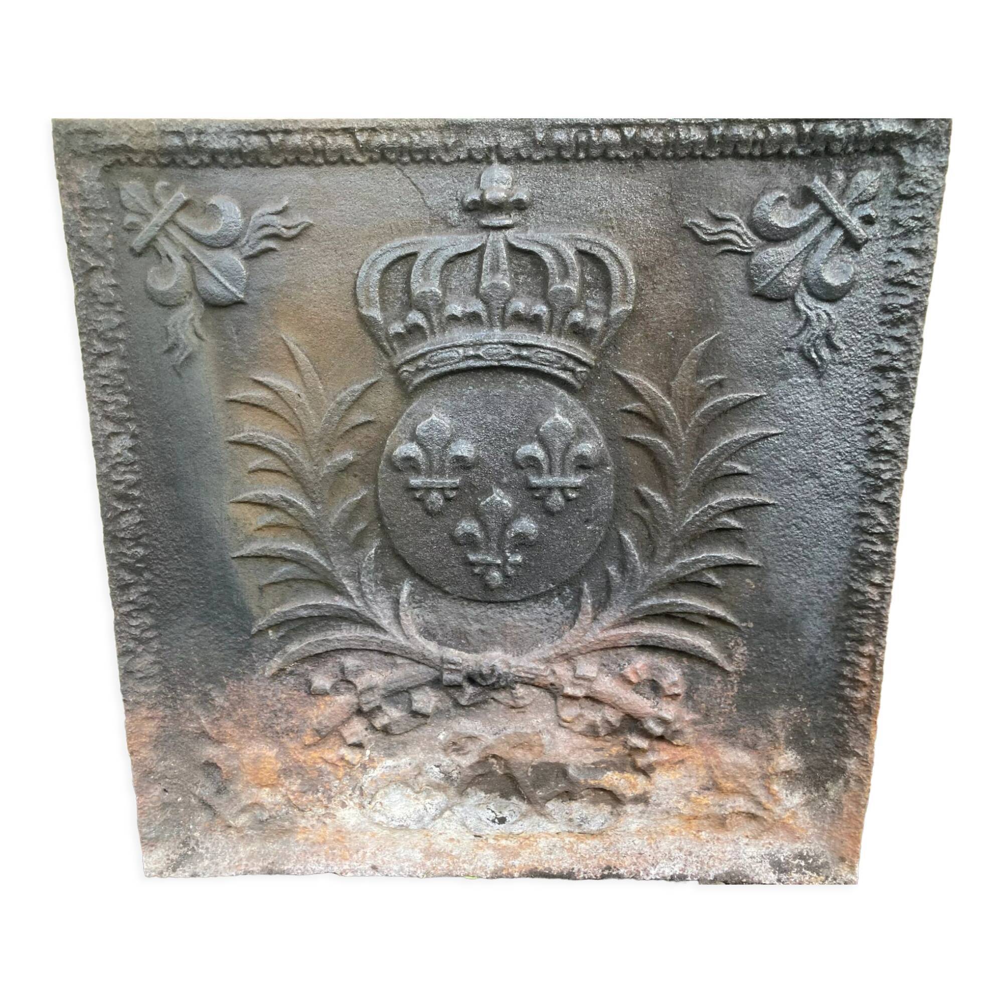 Old cast iron fireback with royal coat of arms