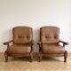 Pair of vintage 1970s armchairs in solid oak and cognac faux leather.