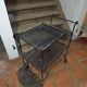 Perforated wrought iron rolling dessert trolley