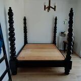 Black, solid wood four-poster bed, made by a craftsman in Mexico