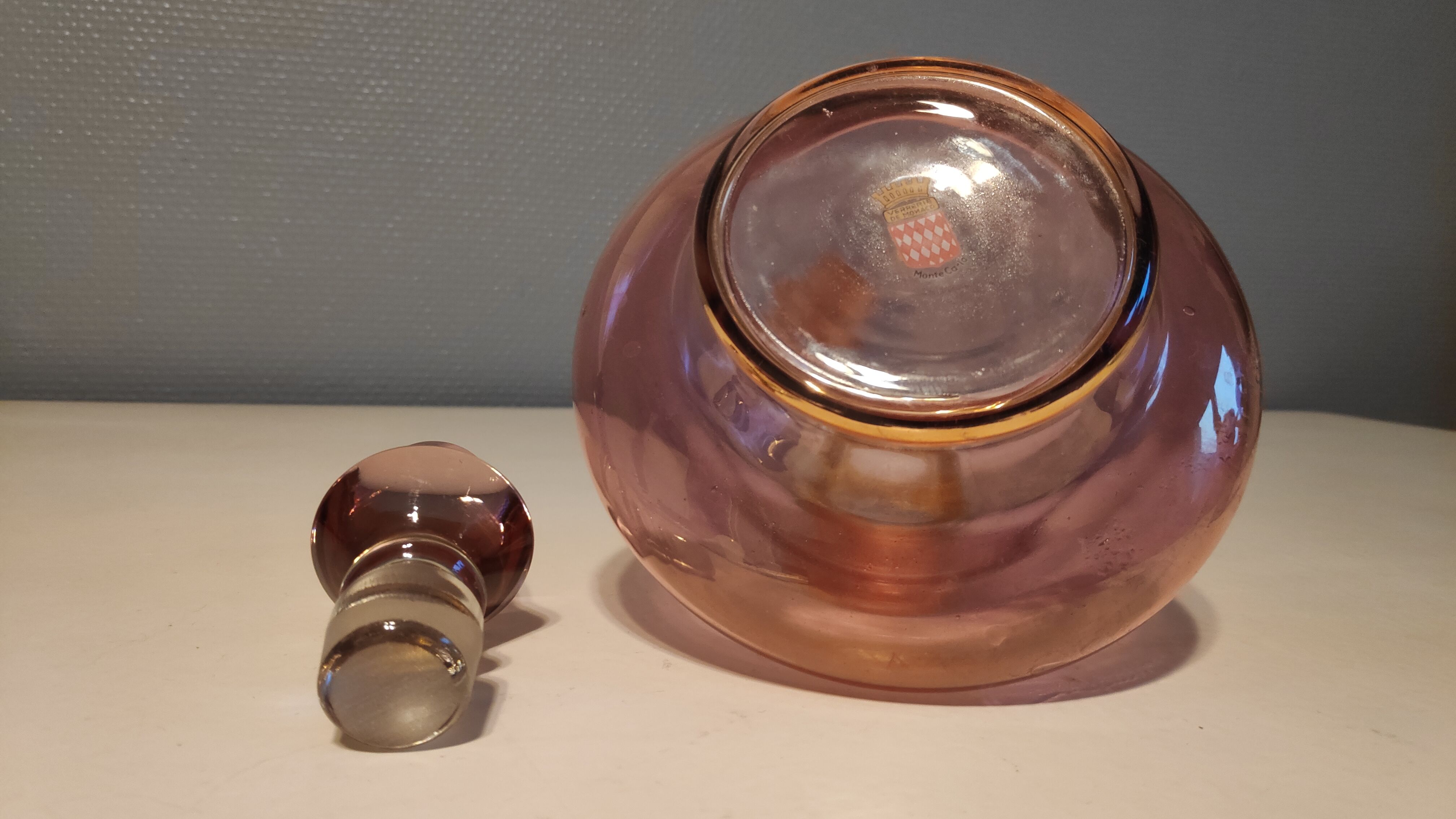 Pink and gold glass carafe stamped "Monaco glassware"