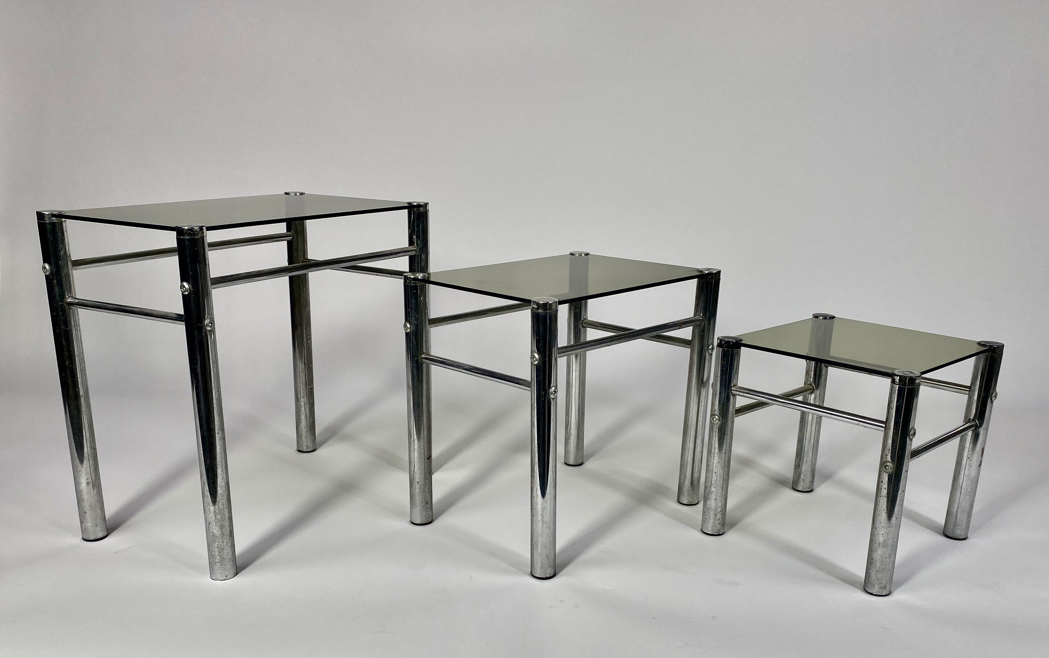 Tables in chrome metal and tinted glass. year 70