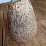 Small asymmetrical golden seed-shaped vase