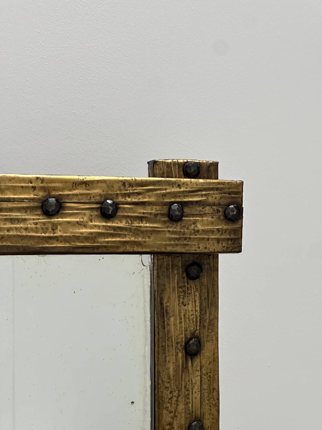 Brutalist mirror with a hammered copper and brass frame.