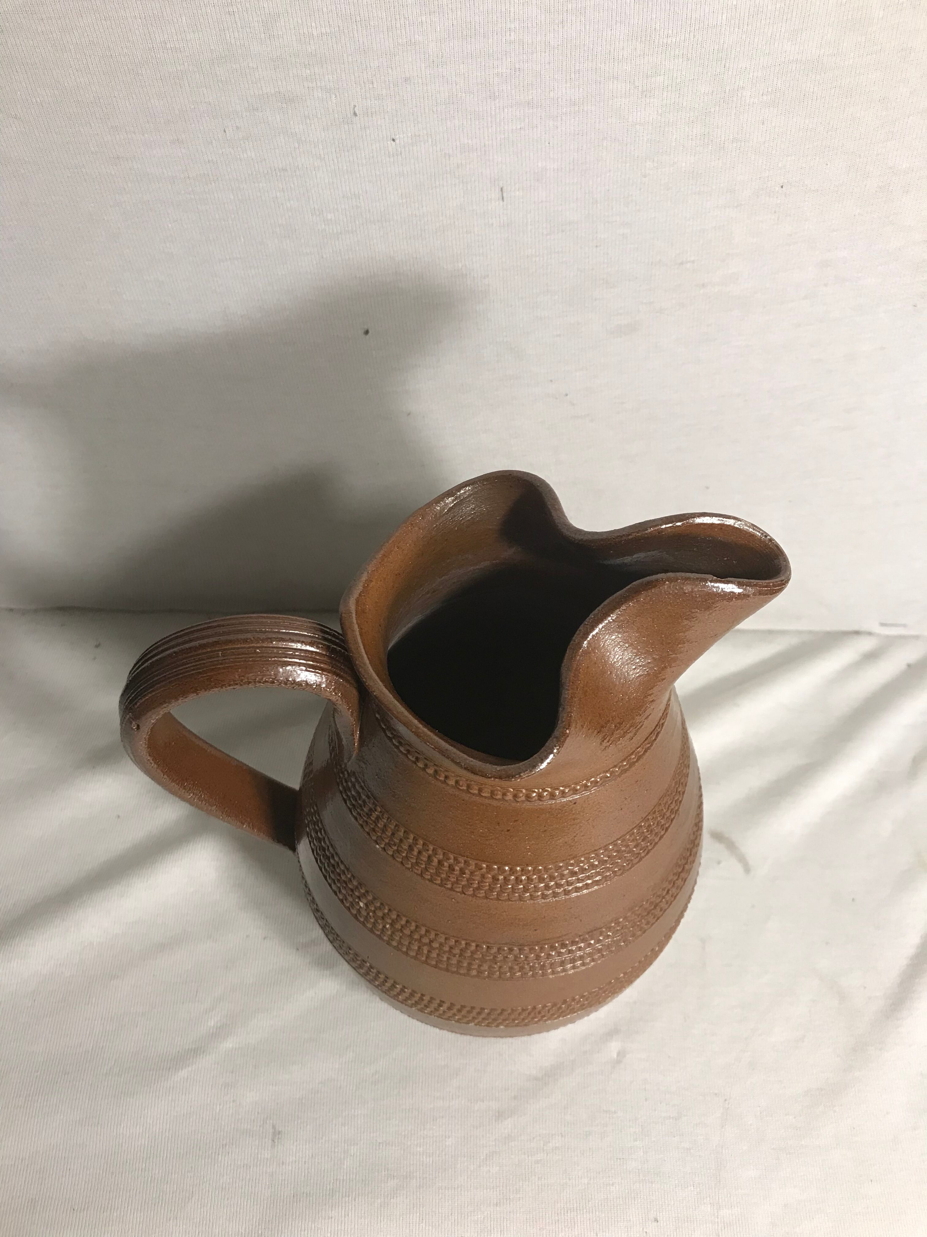 Old brown glazed ceramic jug from the 1950s