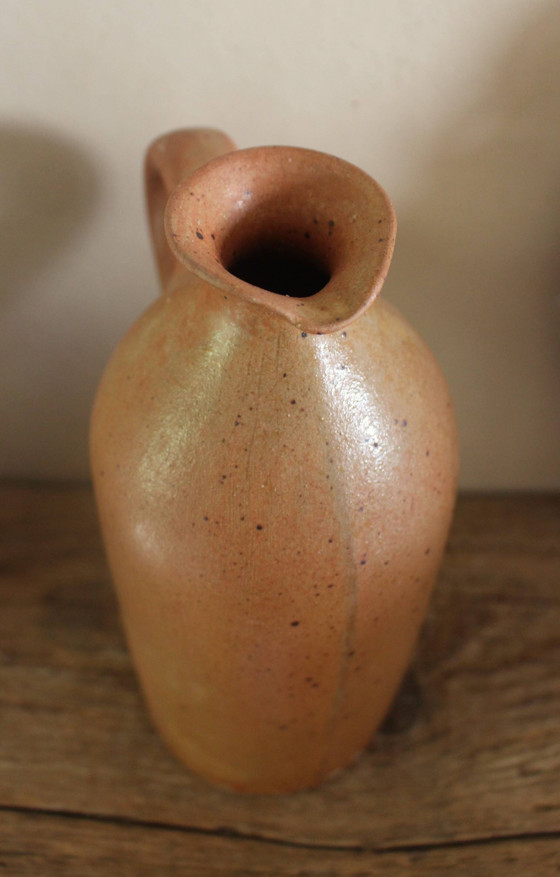Vintage stoneware liqueur bottle with handle
