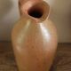Vintage stoneware liqueur bottle with handle