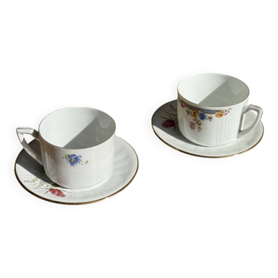 Paire de tasses blanches en porcelaine ADP France à motif floral et leurs s