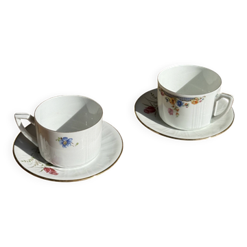 Paire de tasses blanches en porcelaine ADP France à motif floral et leurs s