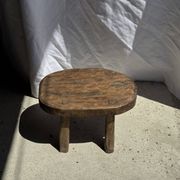 Small stool, oval solid teak side table with curved legs in wabi-sabi style.