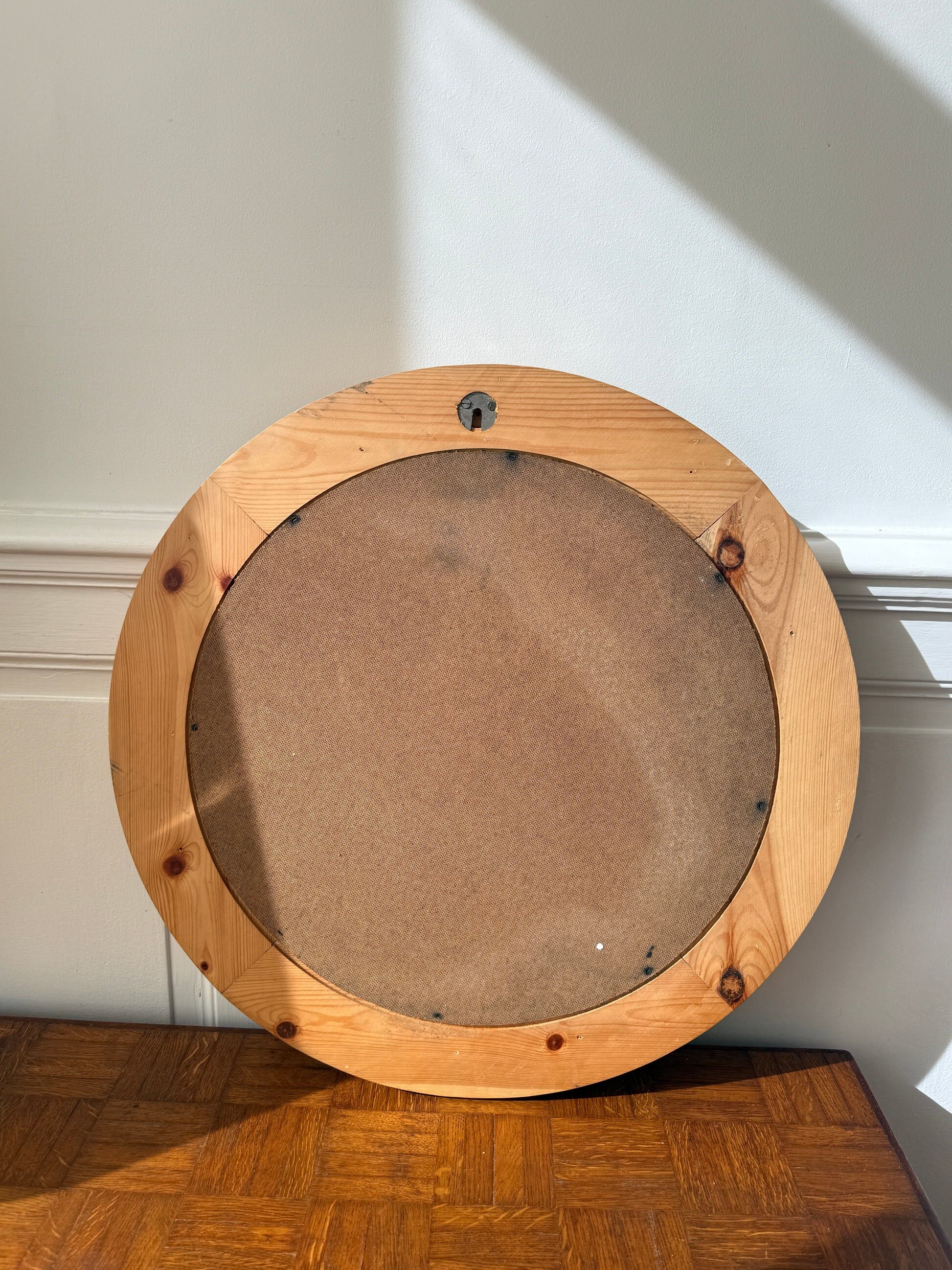 Round mirror in raw wood
