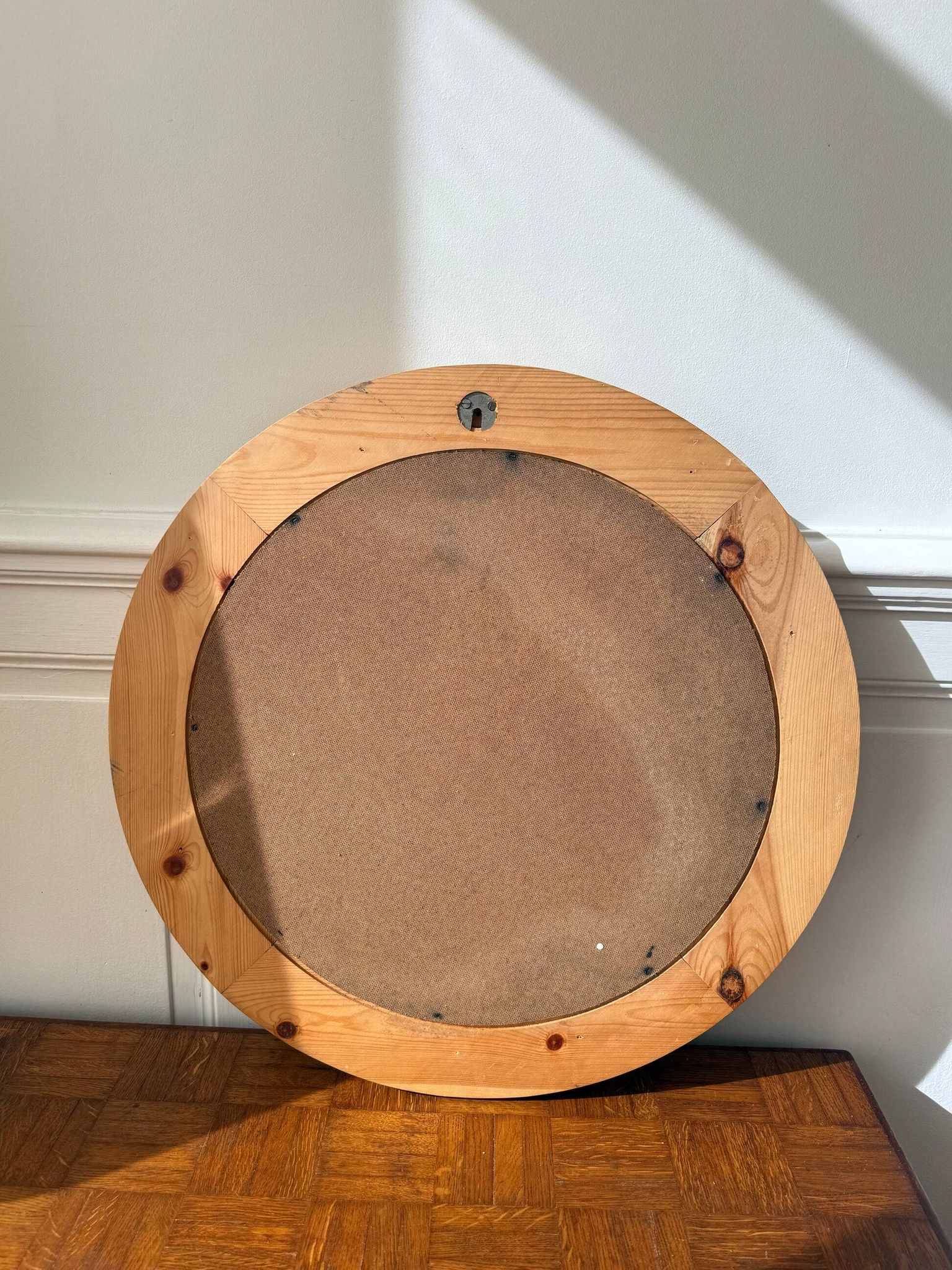 Round mirror in raw wood