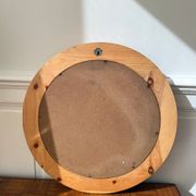Round mirror in raw wood