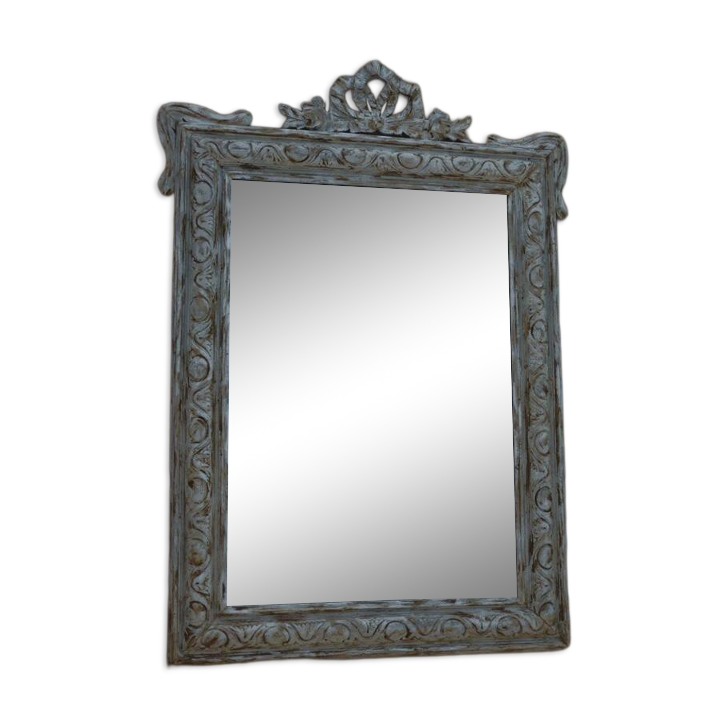 Chic and stylish antique mirror with carved wooden frame in whitewashed
