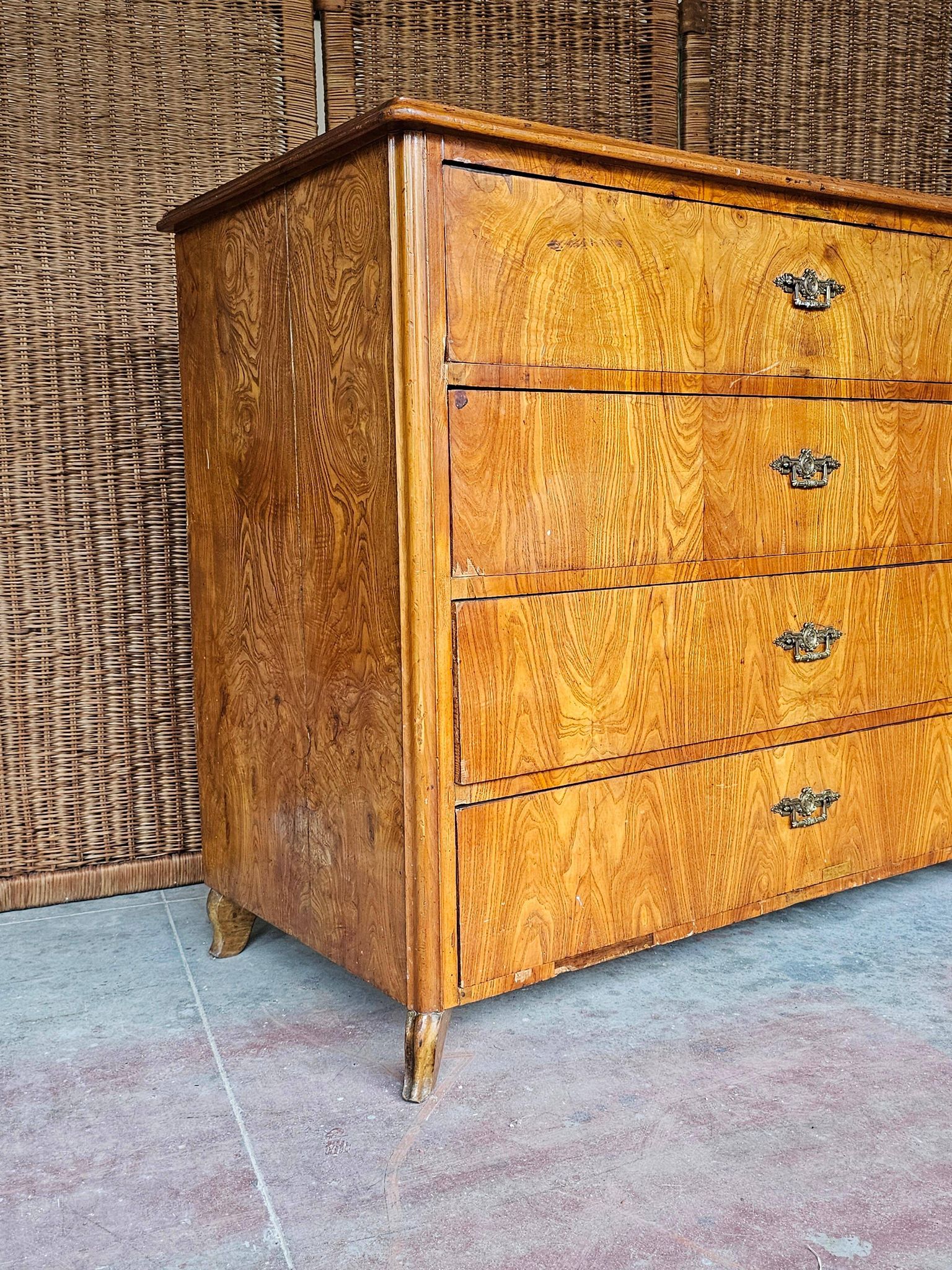 Large antique Biedermeier-style chest of drawers with wood grain.