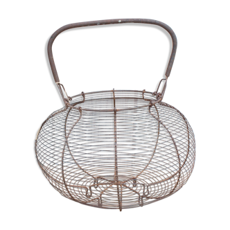 Old basket has wire eggs