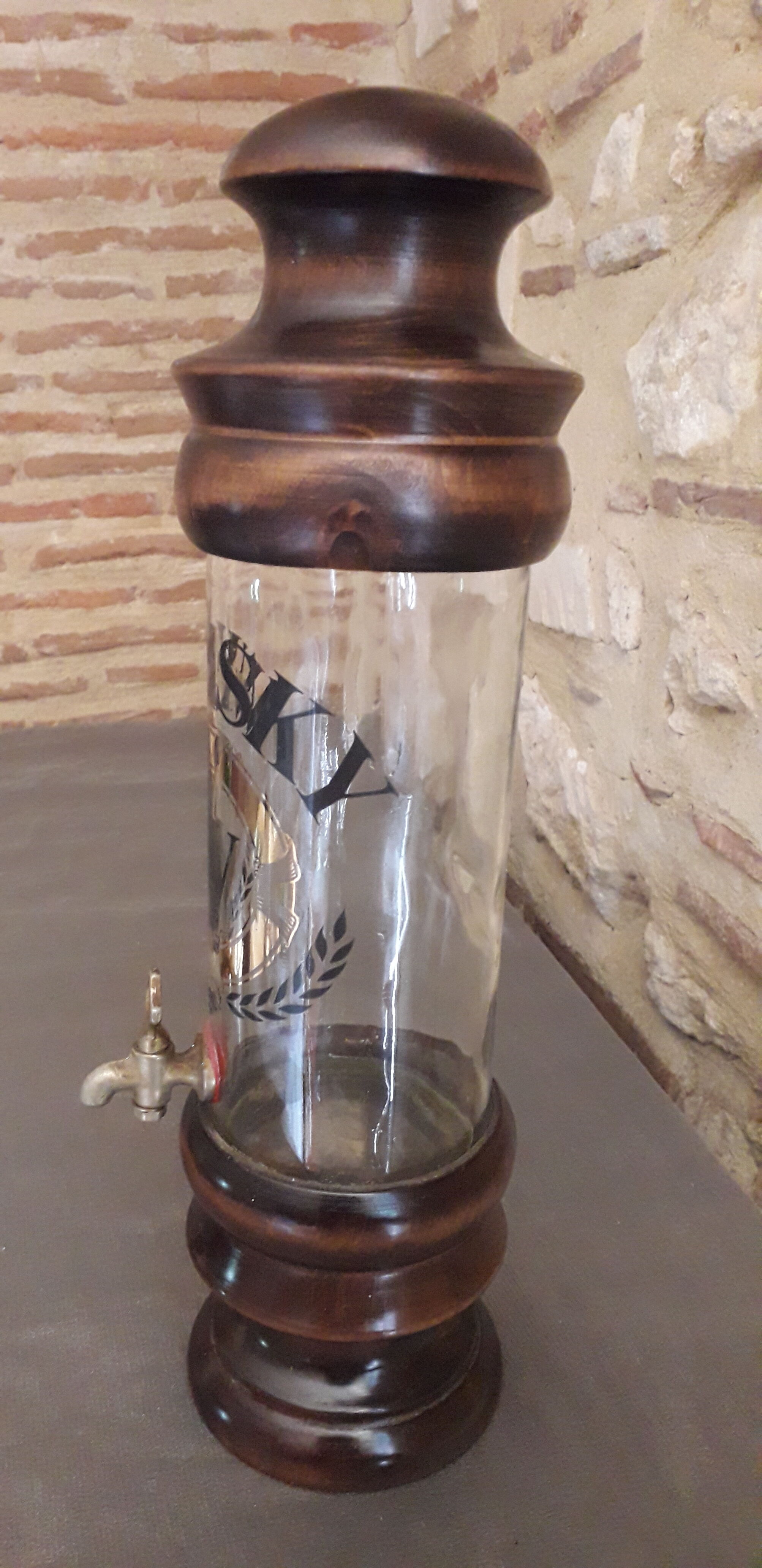 Vintage glass and wood whiskey bottle with pouring tap