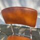 3 chaises vintage en inox et simili-cuir marron