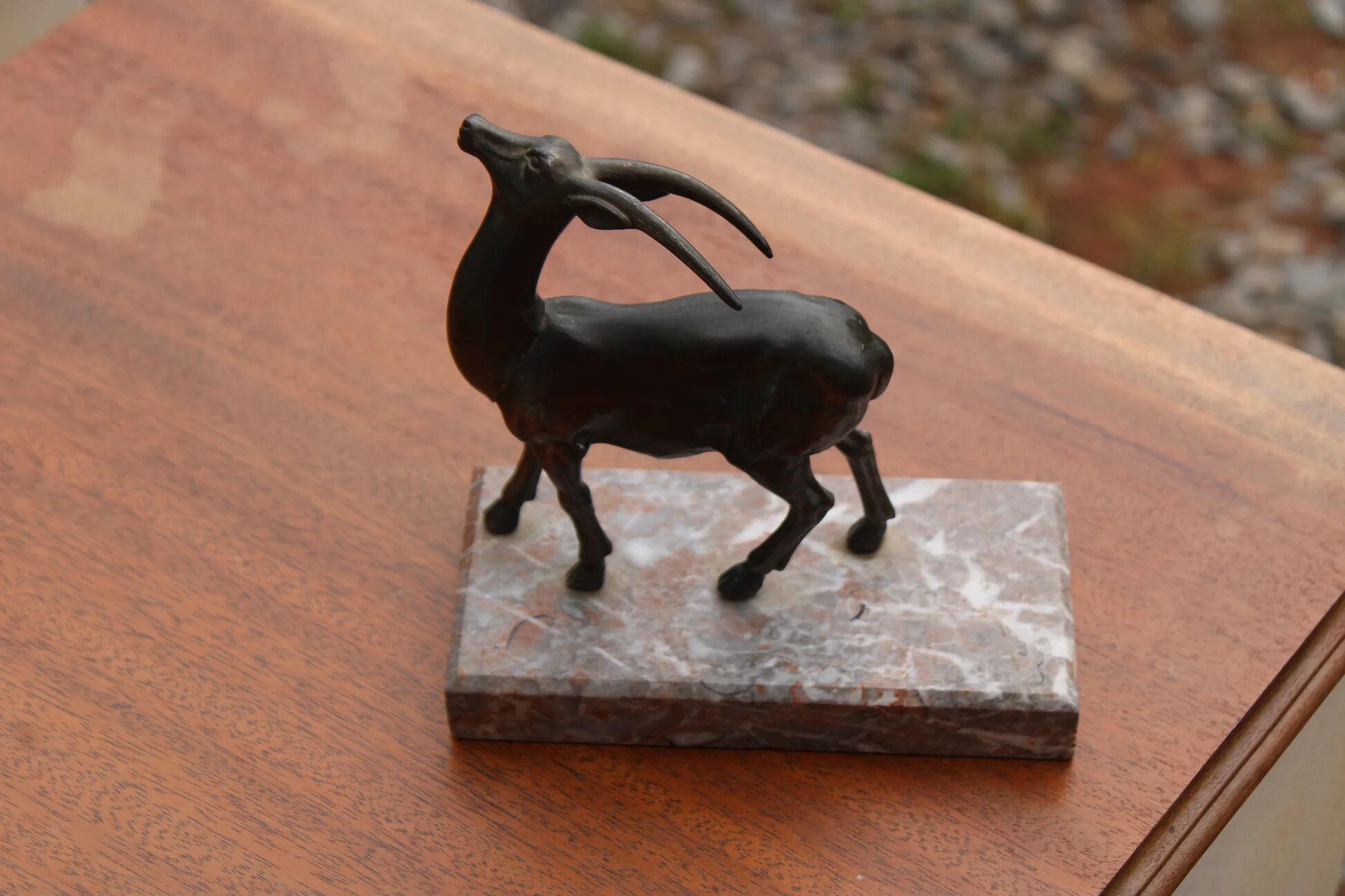 Vintage antelope gazelle bookend in patinated metal on a marble base.