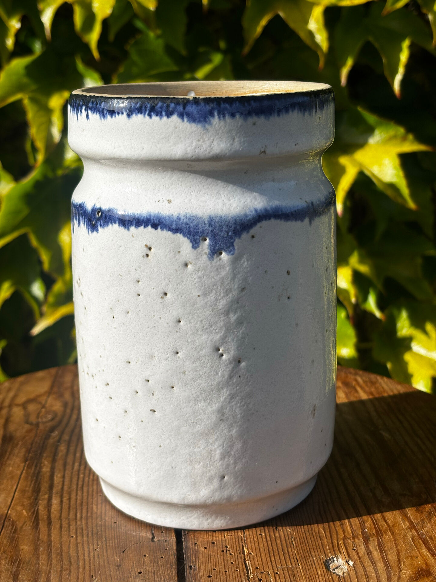 Pretty pot or vase in glazed stoneware with blue drip effect.
