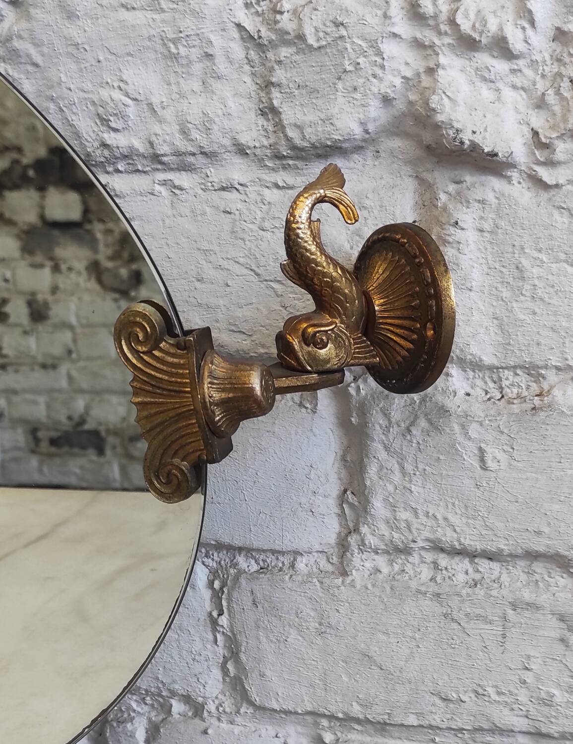 Vintage oval pivoting mirror in gilded brass with dolphins / Barber