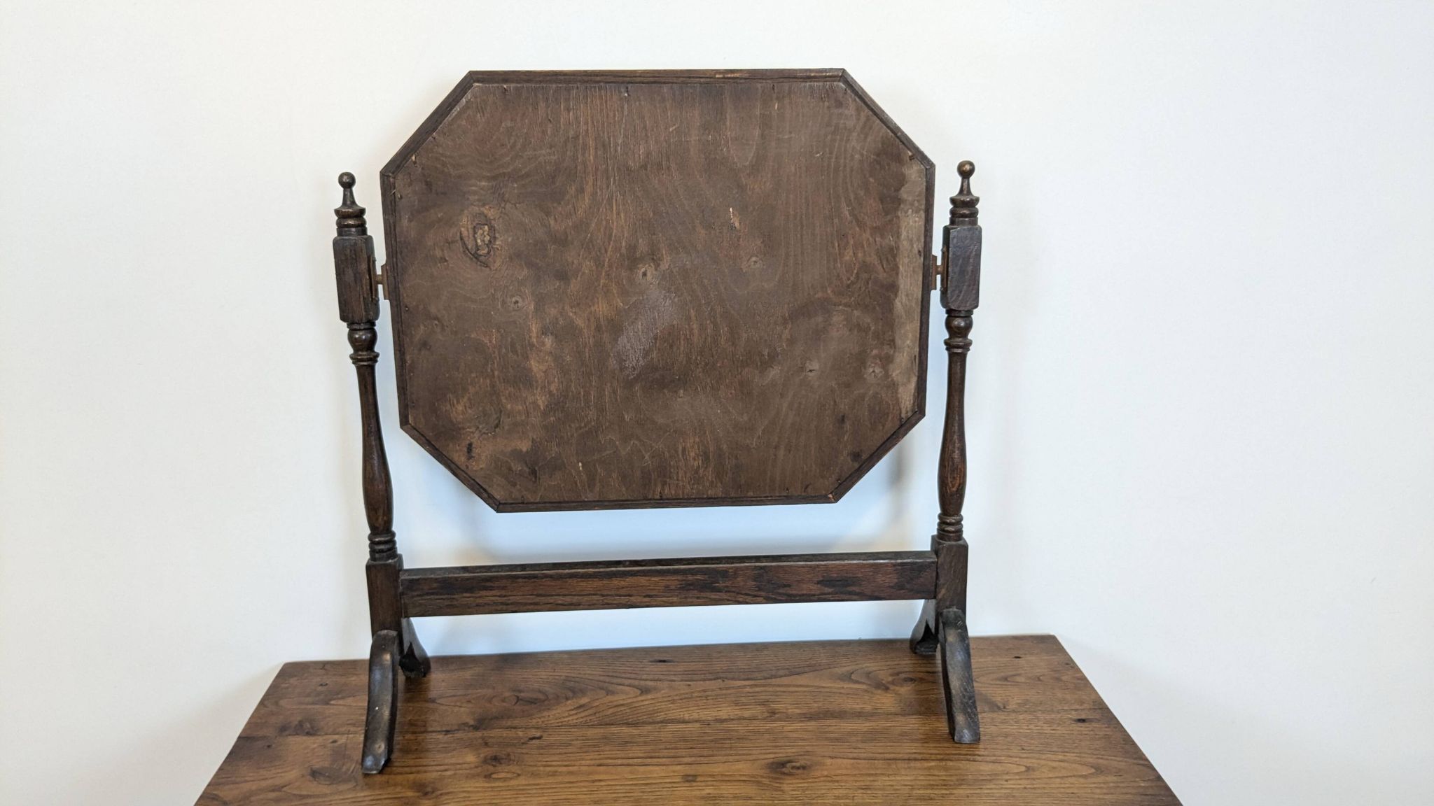 Antique beveled octagonal vanity mirror in carved wood