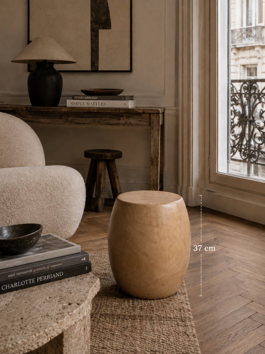 Brutalist monoxyle stool in solid mango wood with an organic shape.