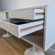 A vintage mid century space age sideboard with white sliding doors