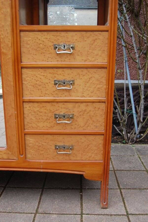 Art Nouveau mirrored wardrobe in mottled maple from the 1930s.