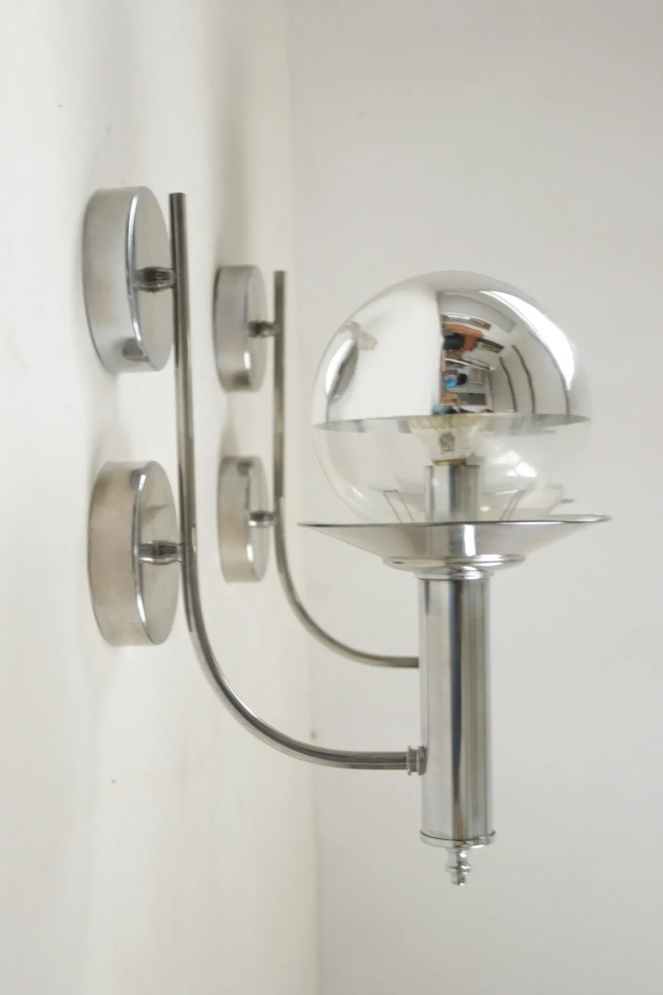 Pair of European mid-century chrome wall sconces with mirrored globe shades