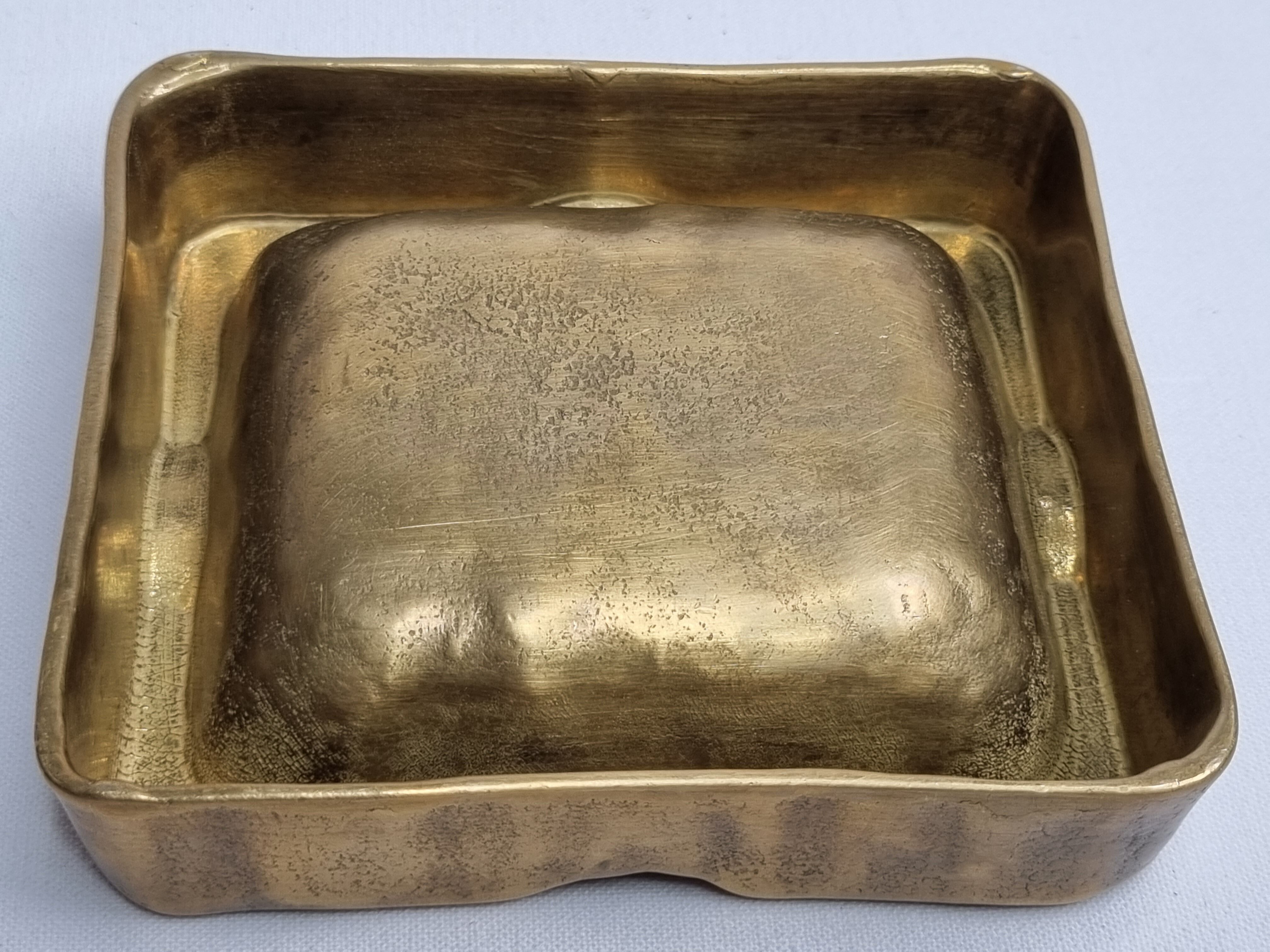 Empty pocket brutalist-inspired ashtray in gilded bronze