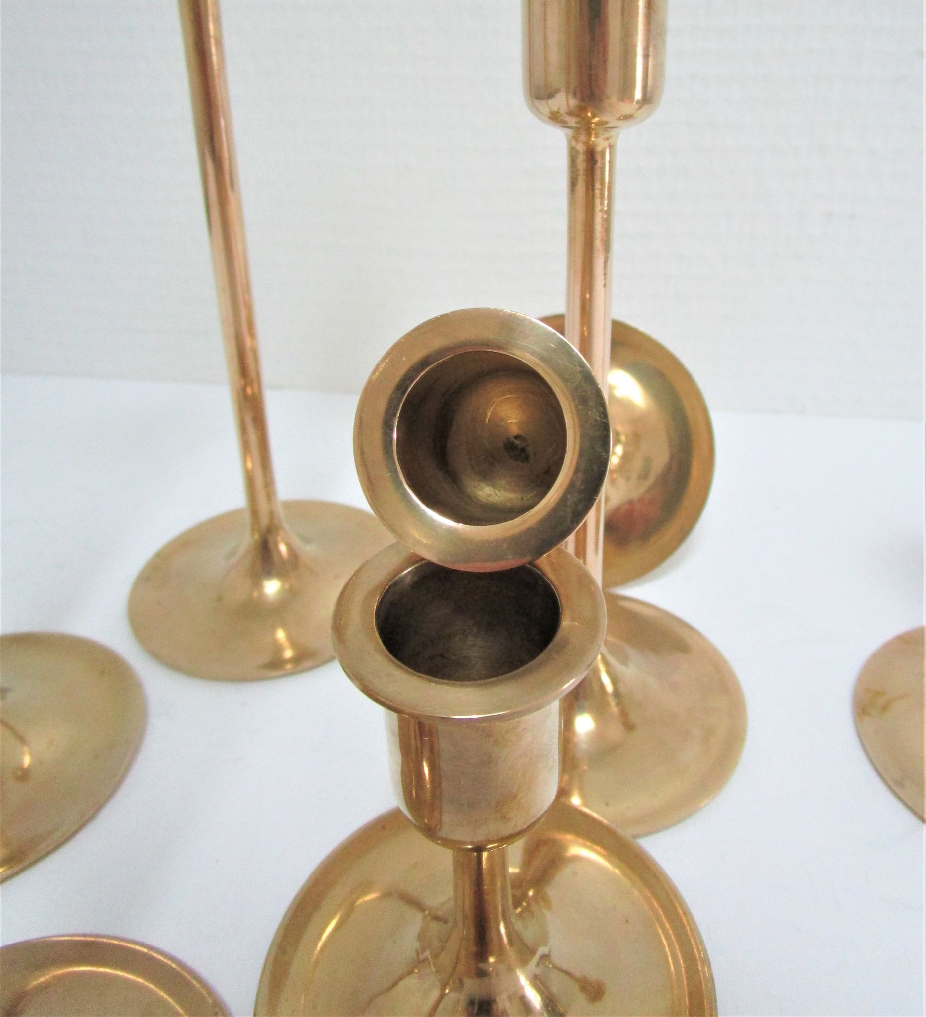 Series of seven candle holders solid brass