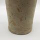 Old hot water bottle in glazed stoneware, beige color