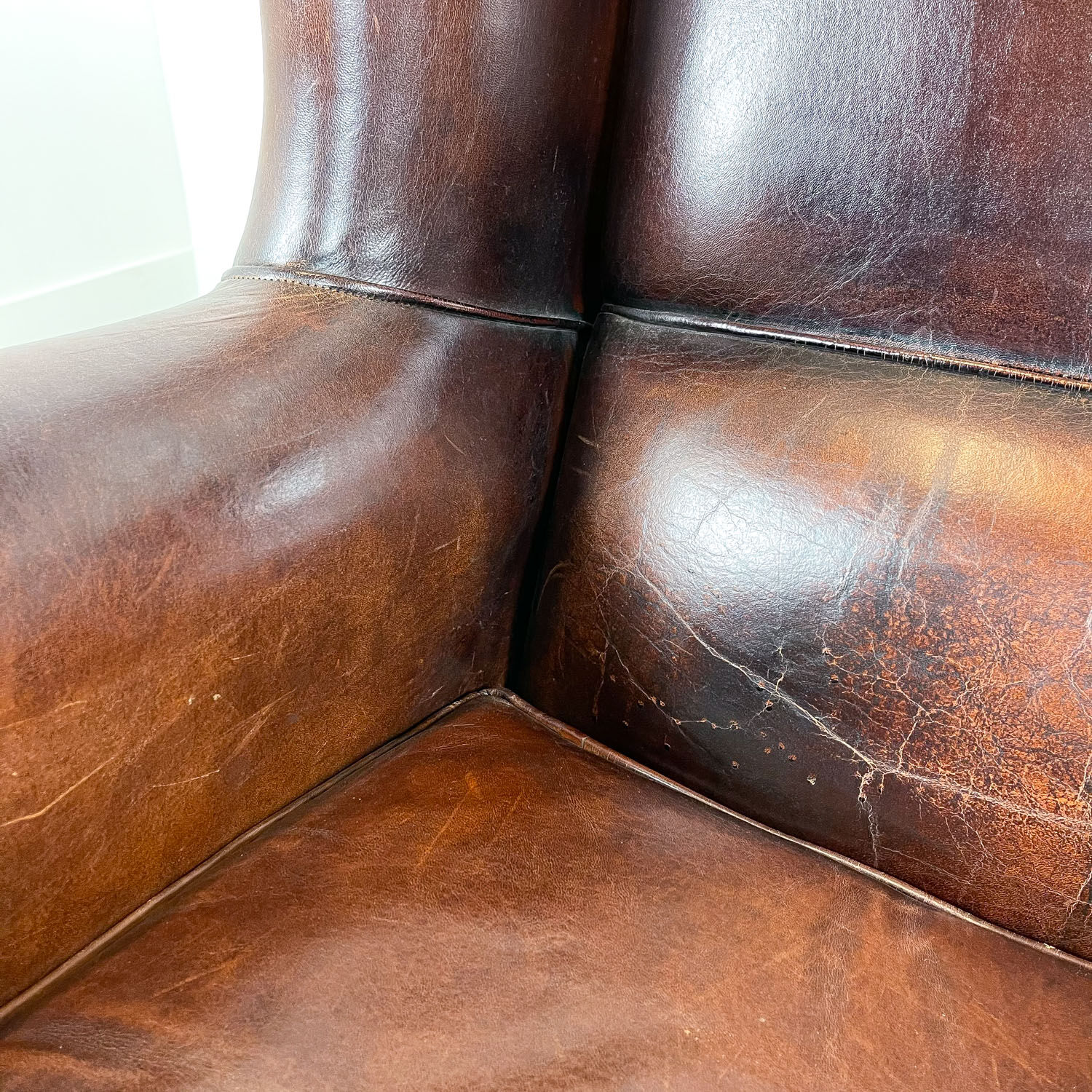 Vintage dark brown sheep leather wingback armchair