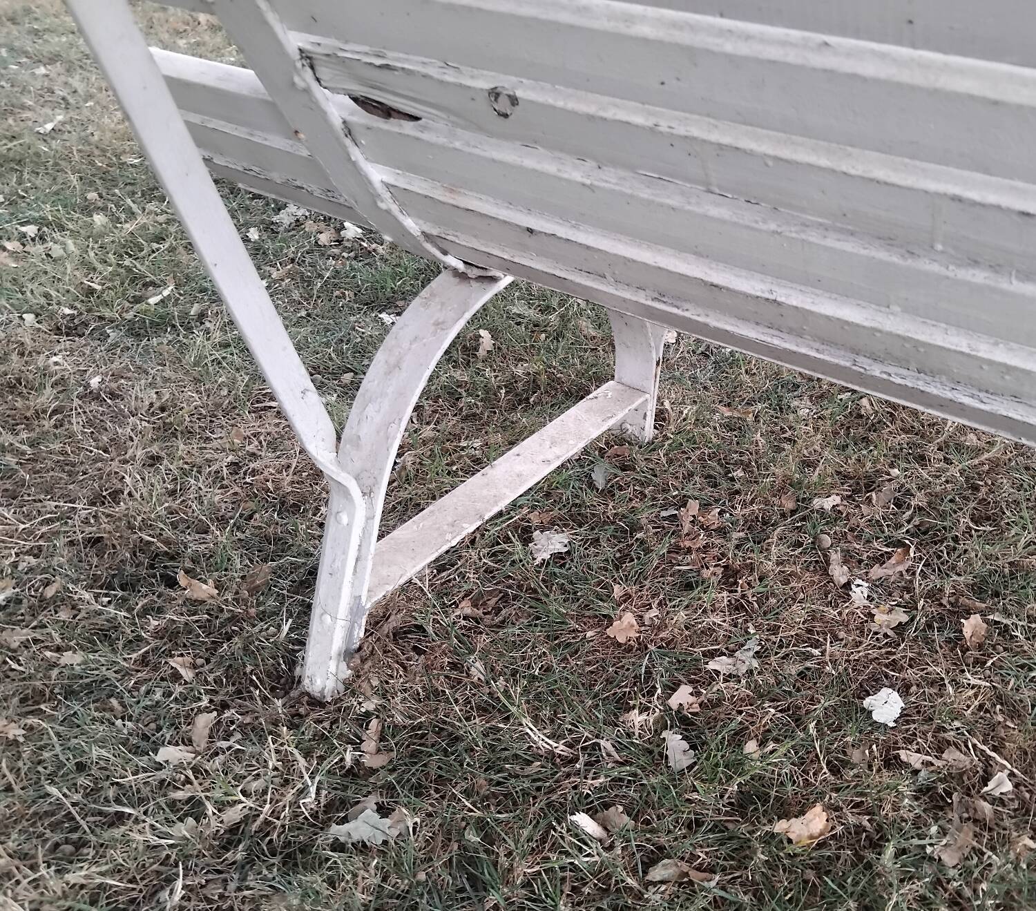 Old garden bench with metal legs and wooden slats