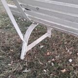 Old garden bench with metal legs and wooden slats