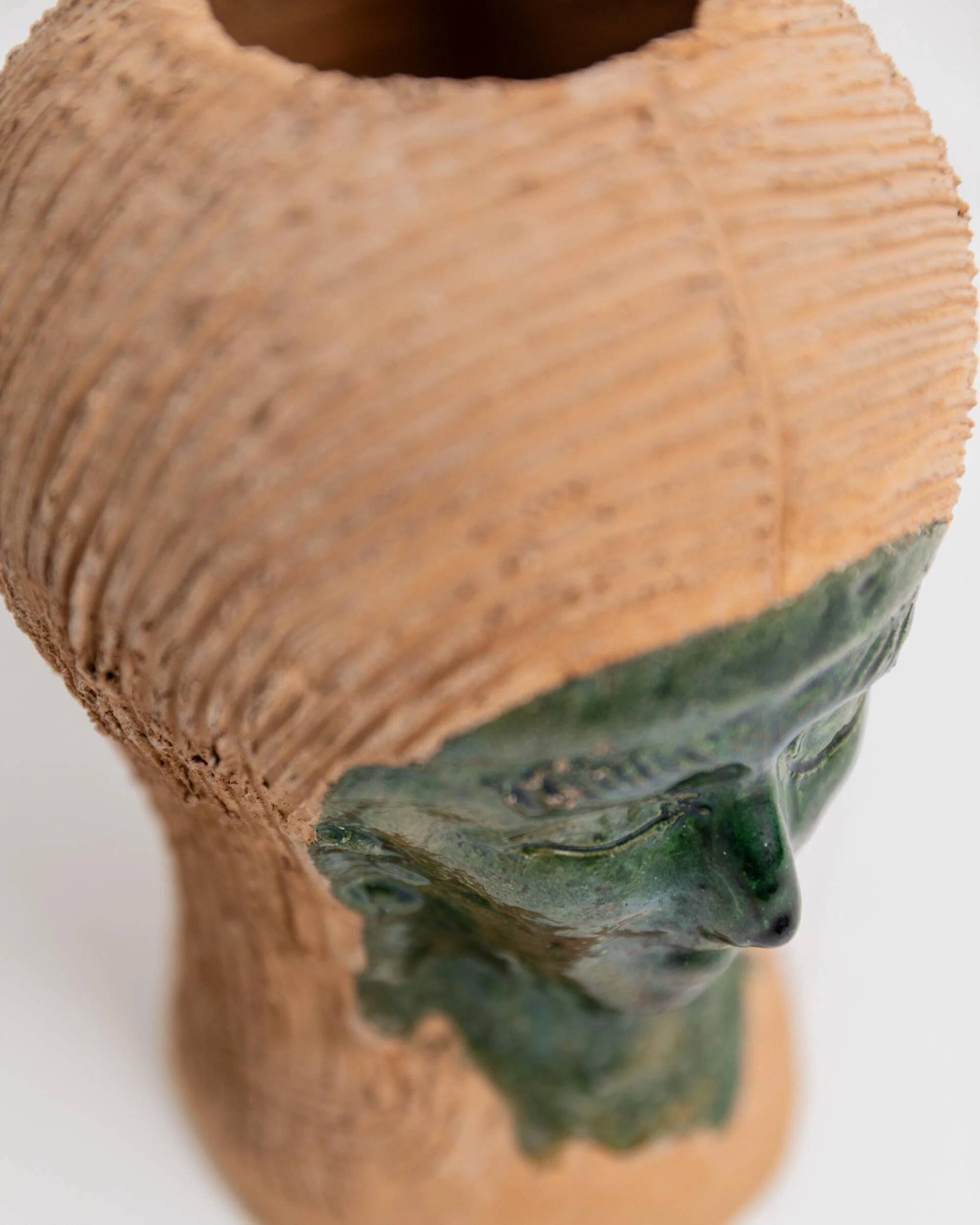 Vintage ceramic vase from the 1980s, sculptural head shape with a green glazed face, terracotta art object.