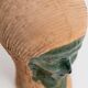 Vintage ceramic vase from the 1980s, sculptural head shape with a green glazed face, terracotta art object.