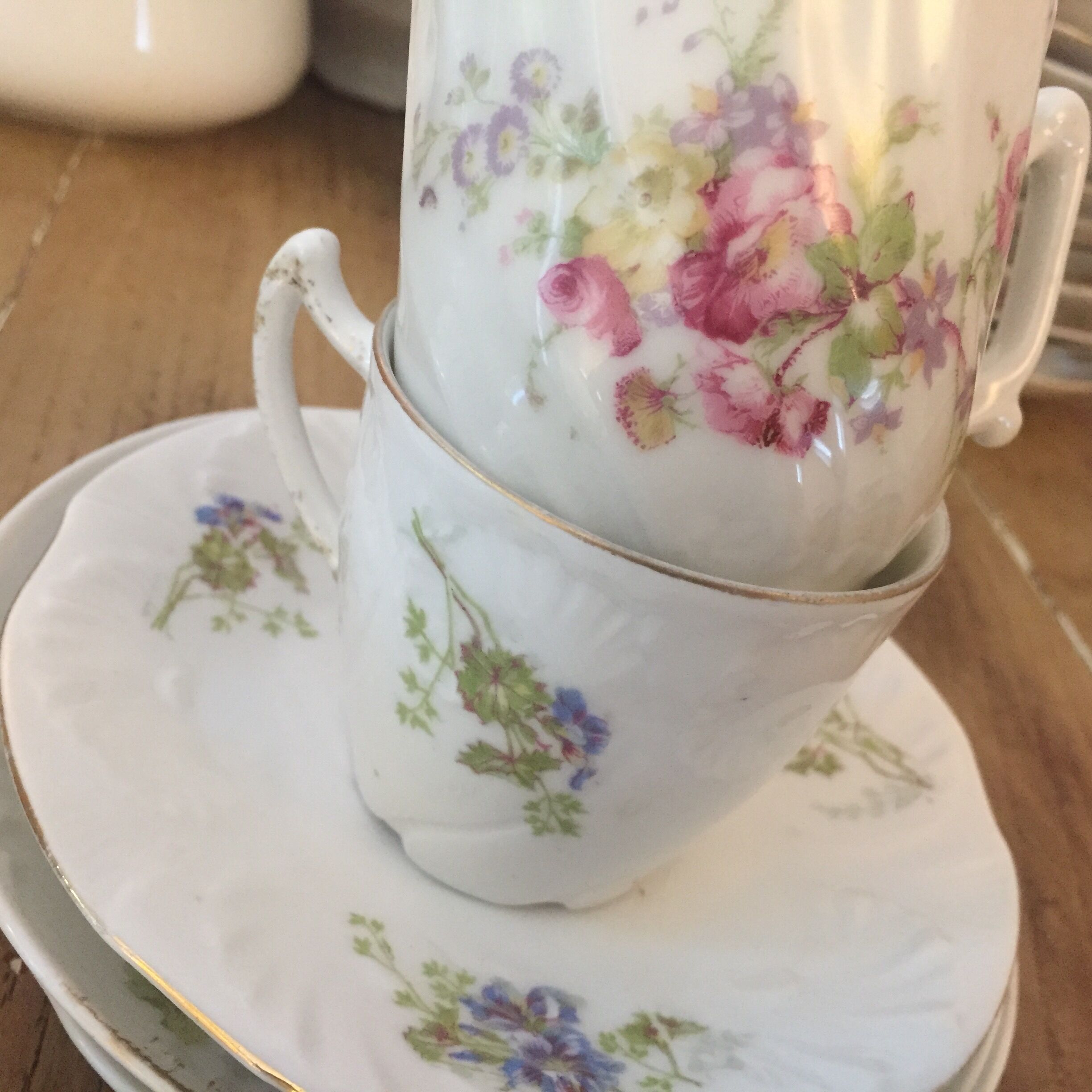 6 antique cups and mismatched saucers